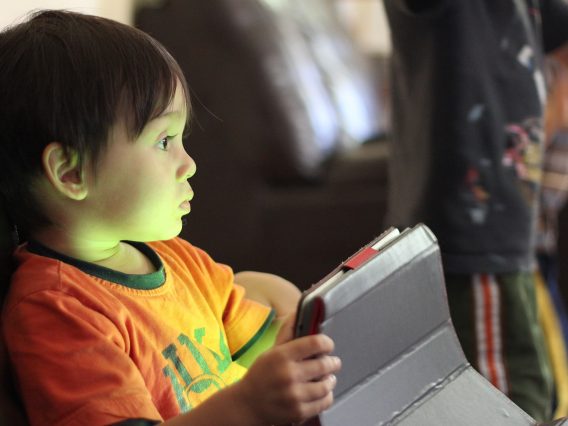 A young child with an iPad